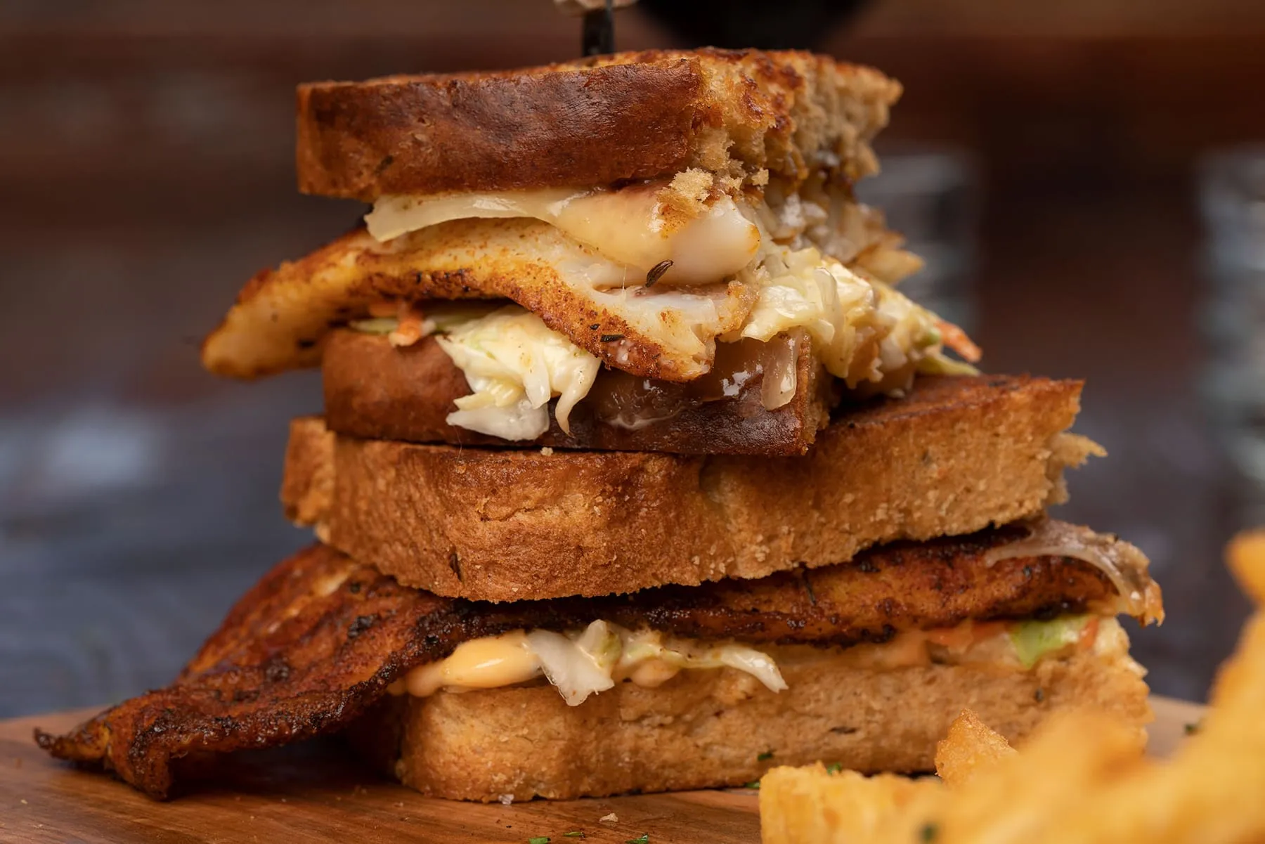 Blackened grouper filet on grilled rye with Swiss and coleslaw