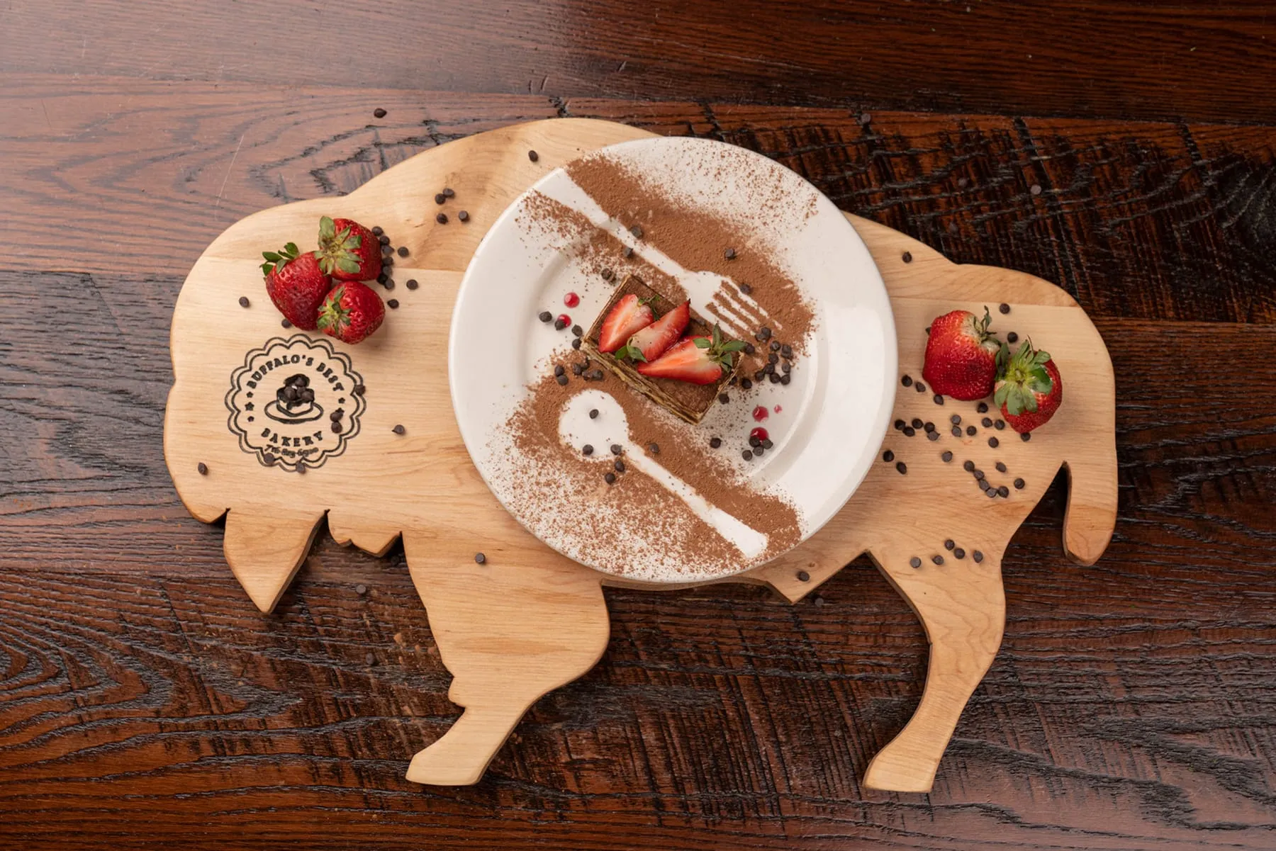 Tiramisu on a board with strawberries, from above
