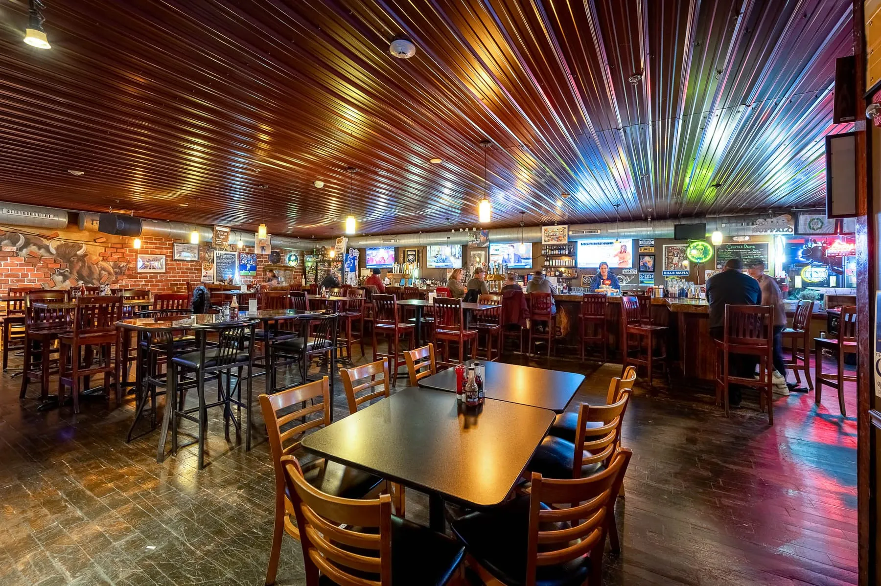 The bar room at Buffalo's Best Grill, with TVs over the bar